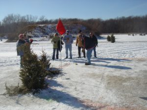 people standing around freezing at the Ice Golf Classic