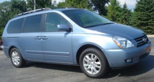 blue Kia Sedona minivan