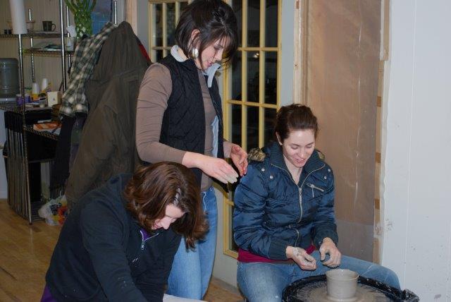 student working on a pottery wheel