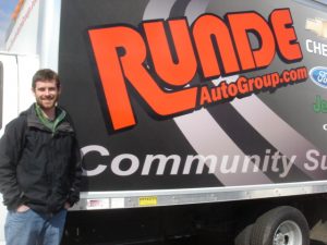 Jordan Degree standing beside the Runde Service Truck