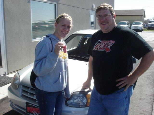 Tiffany and Randy Wuertzer standing in front of their silver new car at Runde's