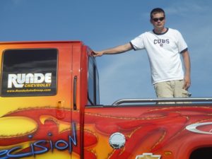 Ryan Halverson standing in the back of a pick up truck