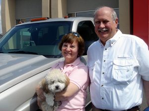 Diana, Robert and Poco Hedtke pictured beside their silver Chevy Silverado diesel