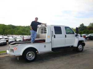 Jeff Schmitt posing in the back of a utility truck