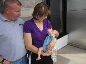 Jason Keane with his wife and baby