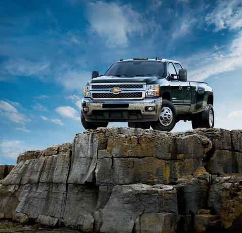 black 2011 Chevrolet Silverado on top of a rocky plateau