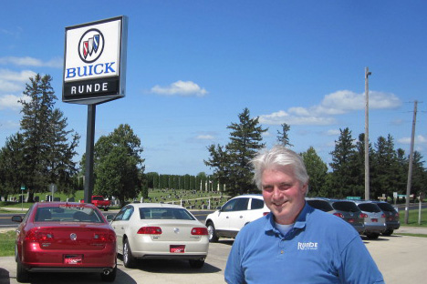 Al Dellabella standing on the car lot in Cuba City