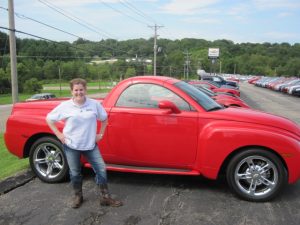 Mariah in front of a red Chevy SSR