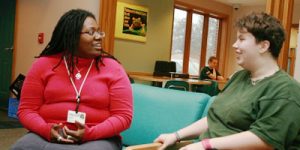 counselor and teen sitting and talking at the Hillcrest Family Services center