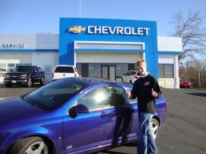 Mike Hafeman standing in front of his blue SS Cobalt