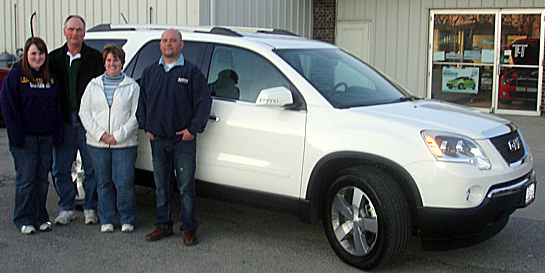 Loras Link and family in front of their GMC Acadai