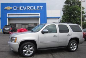 Milo & Mary's new Chevrolet Tahoe LTZ with a red bow on the hood