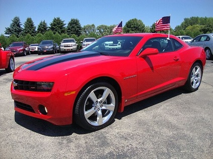 red Camaro with American Flags on the windows