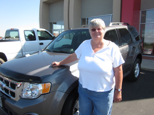 Debbie Straton standing next to her used Ford Escape