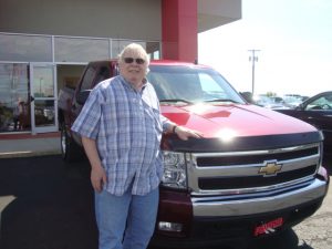 Roy Brock standing beside his new Chevy Silverado crew cab