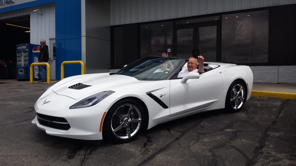 customers in their white Corvette