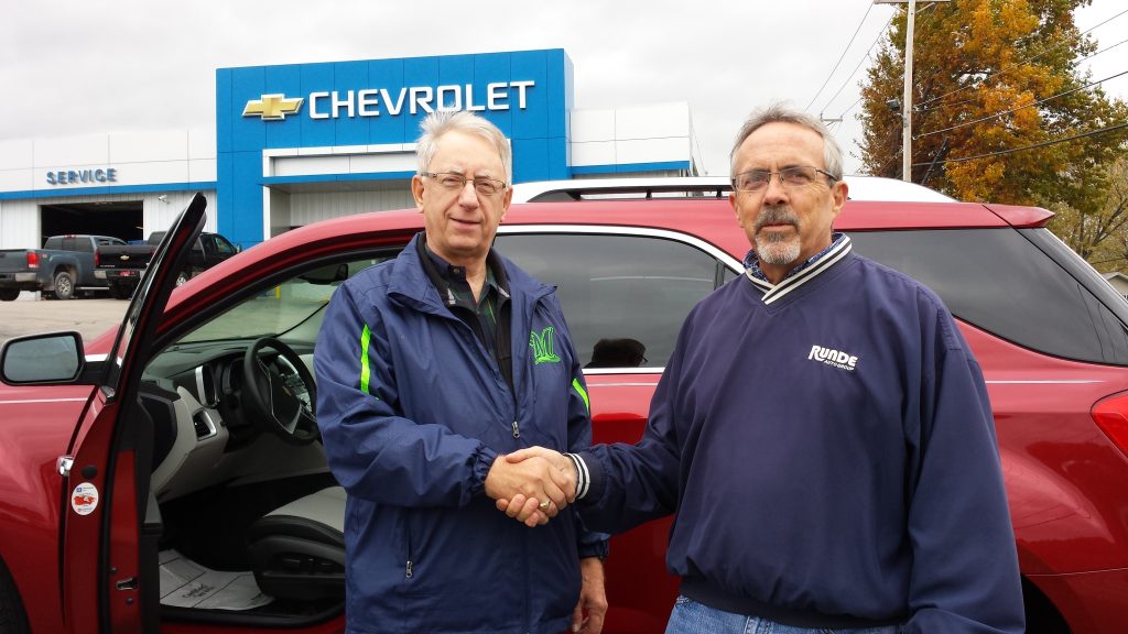 Dick R. standing with his salesman beside his new Equinox