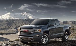 New GMC Canyon parked in front of a snowy covered mountain