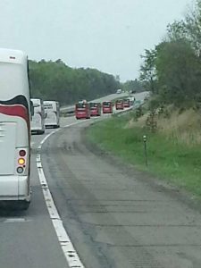 VetsRoll Bus Caravan driving down a highway