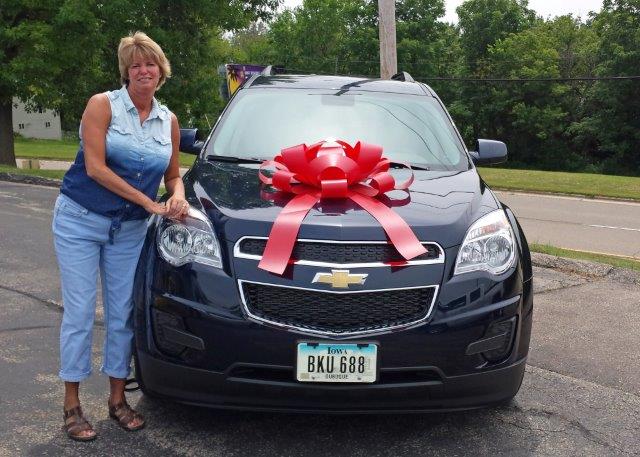 Dubuque Chevy customer Theresa Ernst standing beside her new Equinox