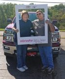 Runde Chevrolet customer holding a sign for the Making Strides Against Breast Cancer campaign