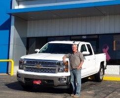 Dubuque Business Owner Eddie Severns standing next to his new truck