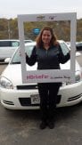 customer standing in front of a white Impala