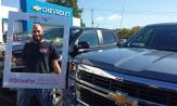 Customer standing in front of a Silverado