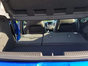 blue Cruze hatchback opened showing the rear seats folded down