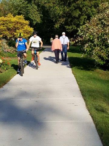 people walking and riding bikes on the Rountree Branch Trail