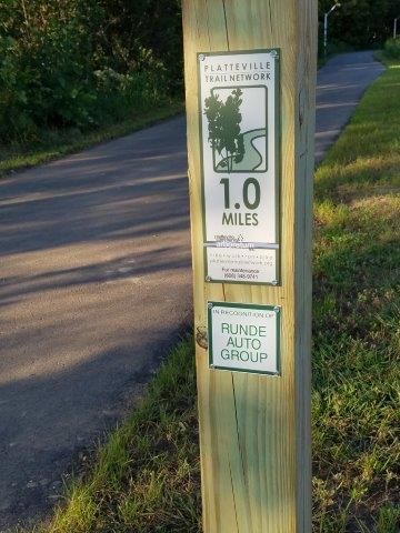 wooden mile marker along the new Rountree Branch Trail