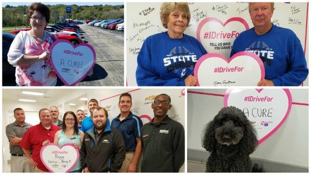 people at Runde Chevrolet holding signs as part of a Chevrolet breast cancer awareness campaign