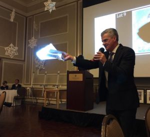 Announcer with microphone at the Dubuque Fundraiser event