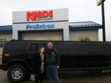 Gary and his wife in front of a black Hummer limosine