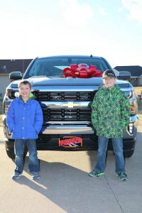 Carolyn's boys pictured in front of the new Silverado