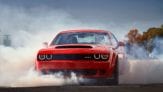 red Dodge Challenger spinning rear tires