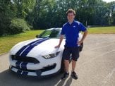 Dan Wahlert standing in front of his Shelby Mustang