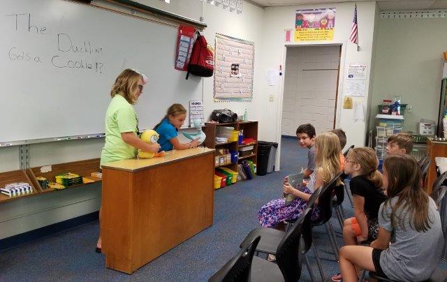 East Dubuque school teacher talking to kids in a classroom