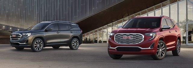 gray and red GMC Terrains parked side by side