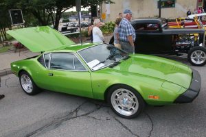 green sports car with trunk open