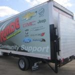 Runde Community Support truck with electronic lift pictured next to the Julien Dubuque Bridge