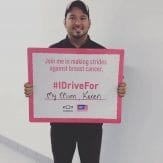 Alan McKee holding a sign for Making Strides Against Breast Cancer