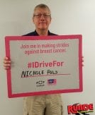 Jim Puls holding an I Drive For Sign