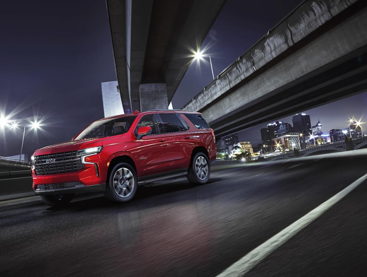 red Chevrolet Tahoe at night