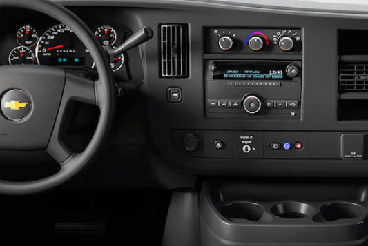 dashboard and front cupholders of a Chevy Express van in Dubuque