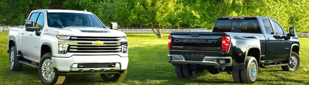 white Chevy 2500 and black Chevy 3500 dually