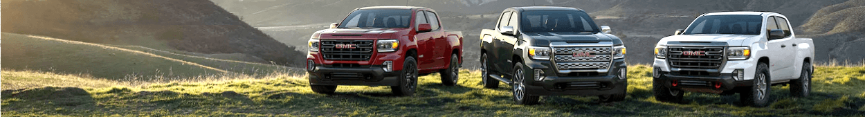 3 GMC Canyon trucks parked on a hilltop