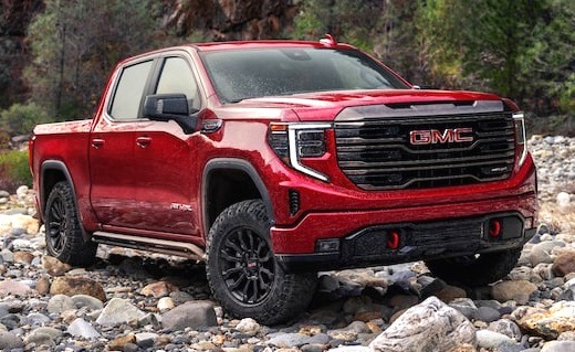 New red Sierra 1500 parked on rocky terrain