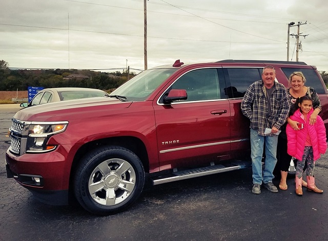 Tricia & Terry M. from Dubuque Iowa pictured here with their daughter in front of the 2018 Chevy Tahoe from Runde Auto Group.